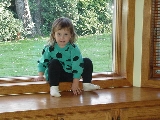 This is a picture of me sitting on the ledge in the sunroom when I was barely 2 years old.